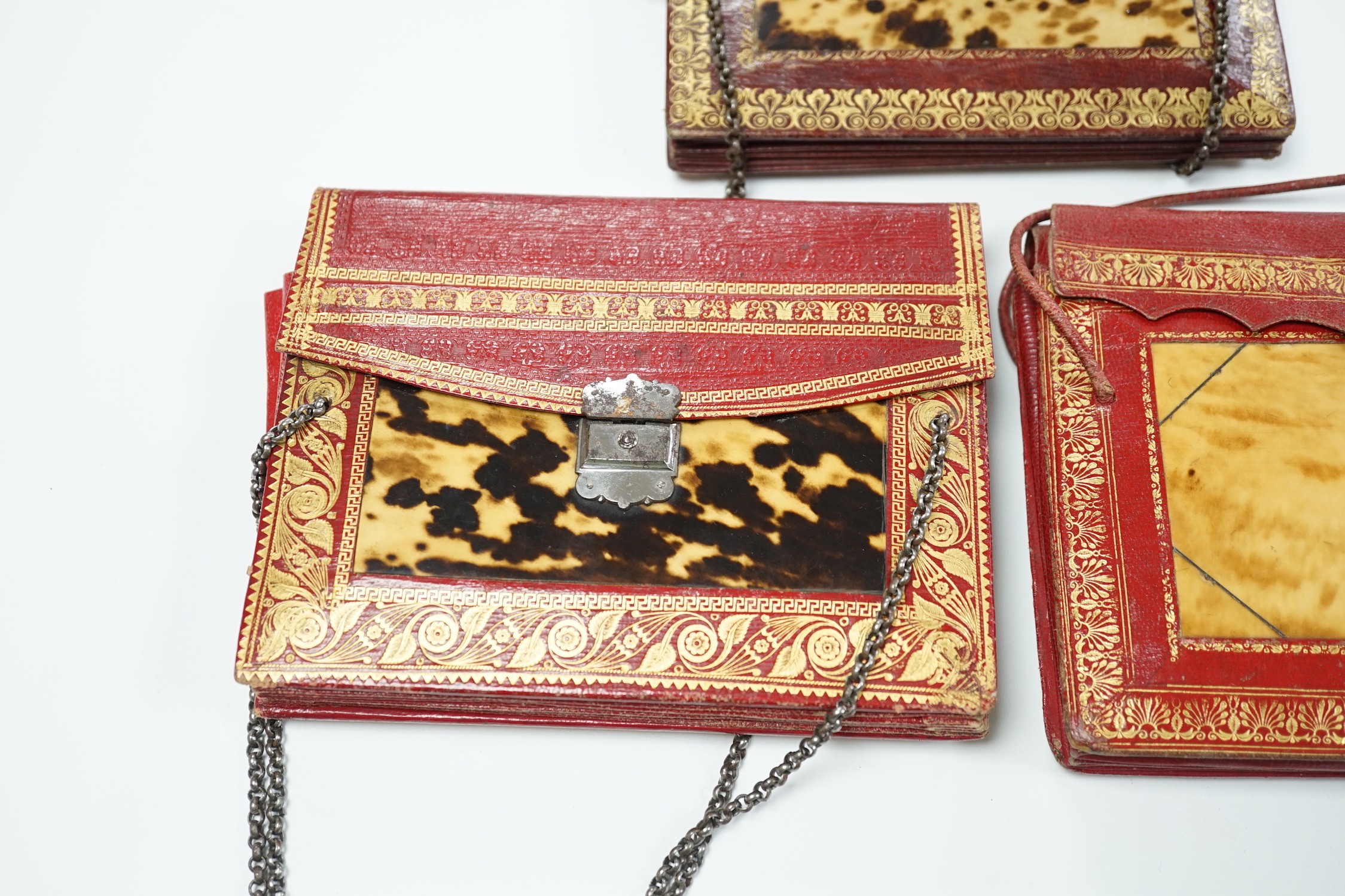 Three rare William IV red and burgundy tooled Moroccan leather and tortoiseshell panelled handbags, two with Scottish thistle shaped cut steel clasps